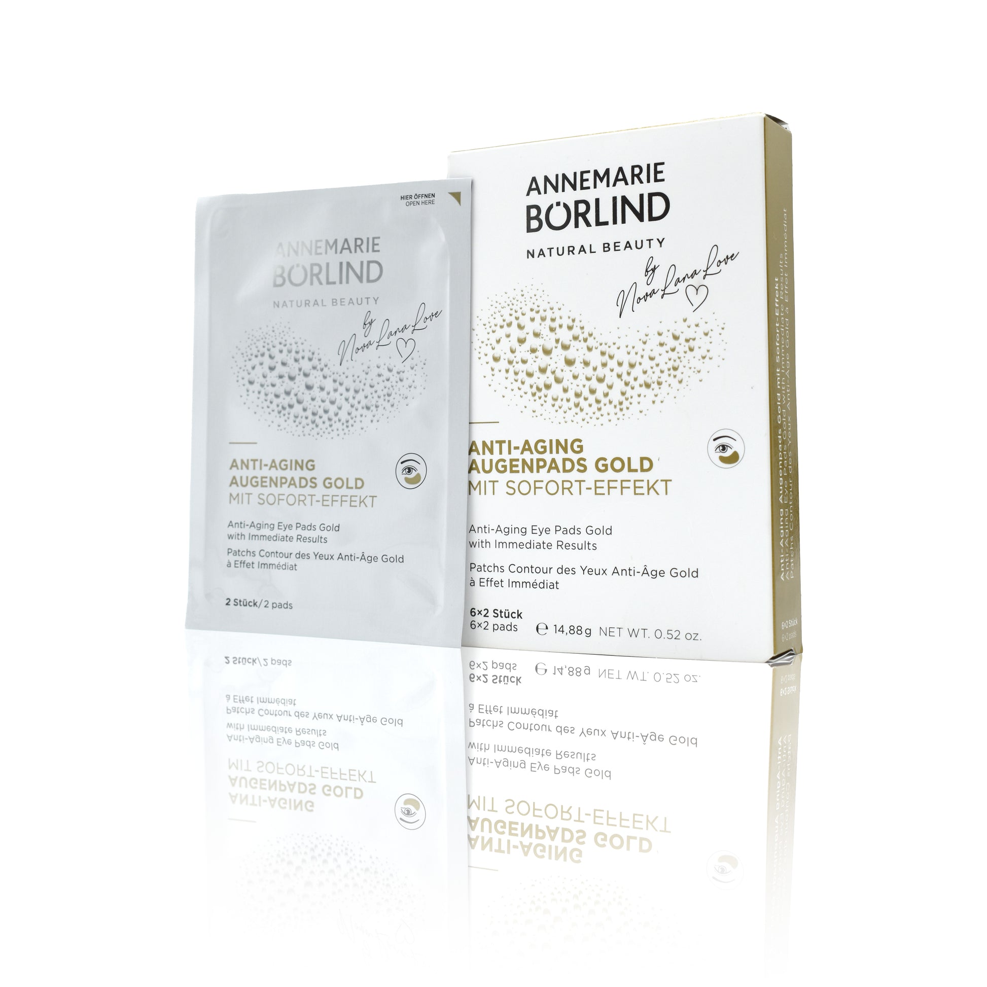Weiße Papierverpackung der goldenen Hyaluron Augenpads mit goldener Beschriftung auf der Verpackung. Im Vordergrund eine ausgepackte Packung zur Ansicht.